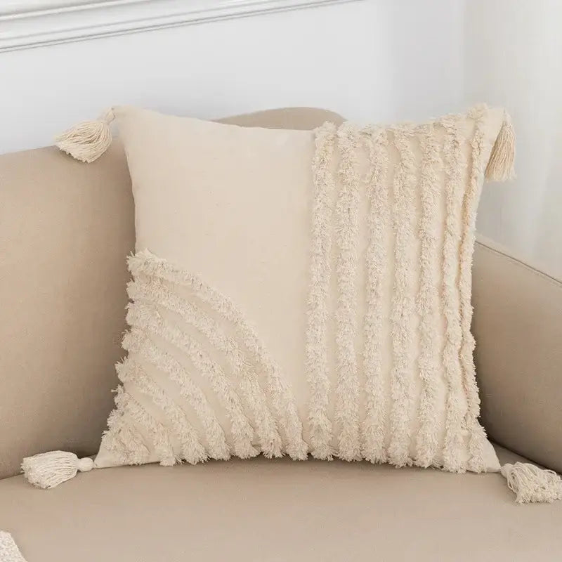 Cream-colored cushion cover with textured fringed fabric and tassels for decorbites beige boho style living room decor