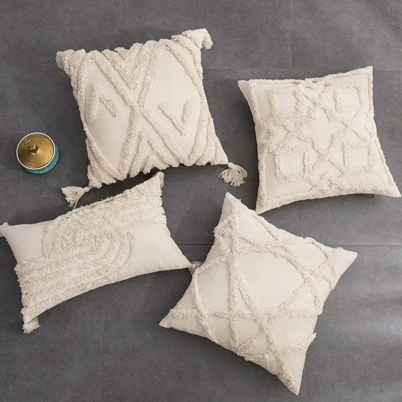 Cream-colored textured woven cushion cover with intricate patterns and tassels for decorbites beige boho style living room