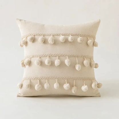 Beige cotton cushion cover with three cream pom-pom rows and lace trim in decorbites beige tufted fringed style