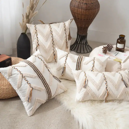 Cream-colored embroidered boho beige tufted pillow cover with geometric woven patterns and tassel accents for living room
