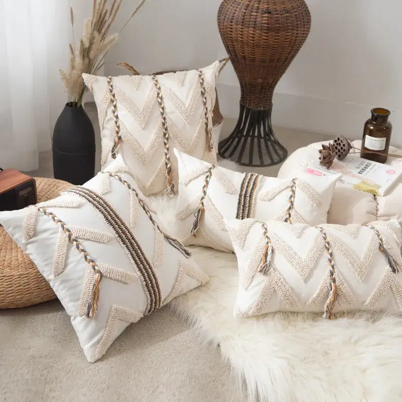 Cream-colored embroidered boho beige tufted pillow cover with geometric woven patterns and tassel accents for living room