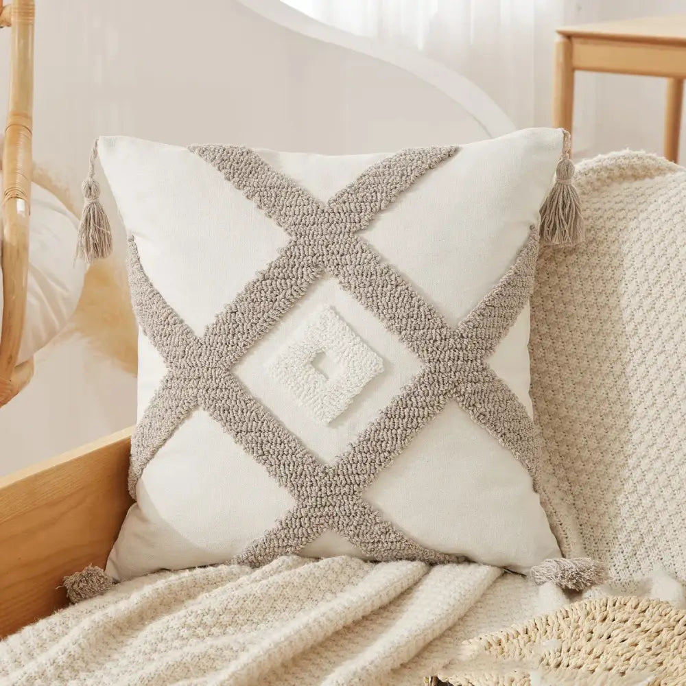 Cream-colored boho beige white pillow cases with textured gray woven cross pattern and tassel fringed decorbites boho beige design