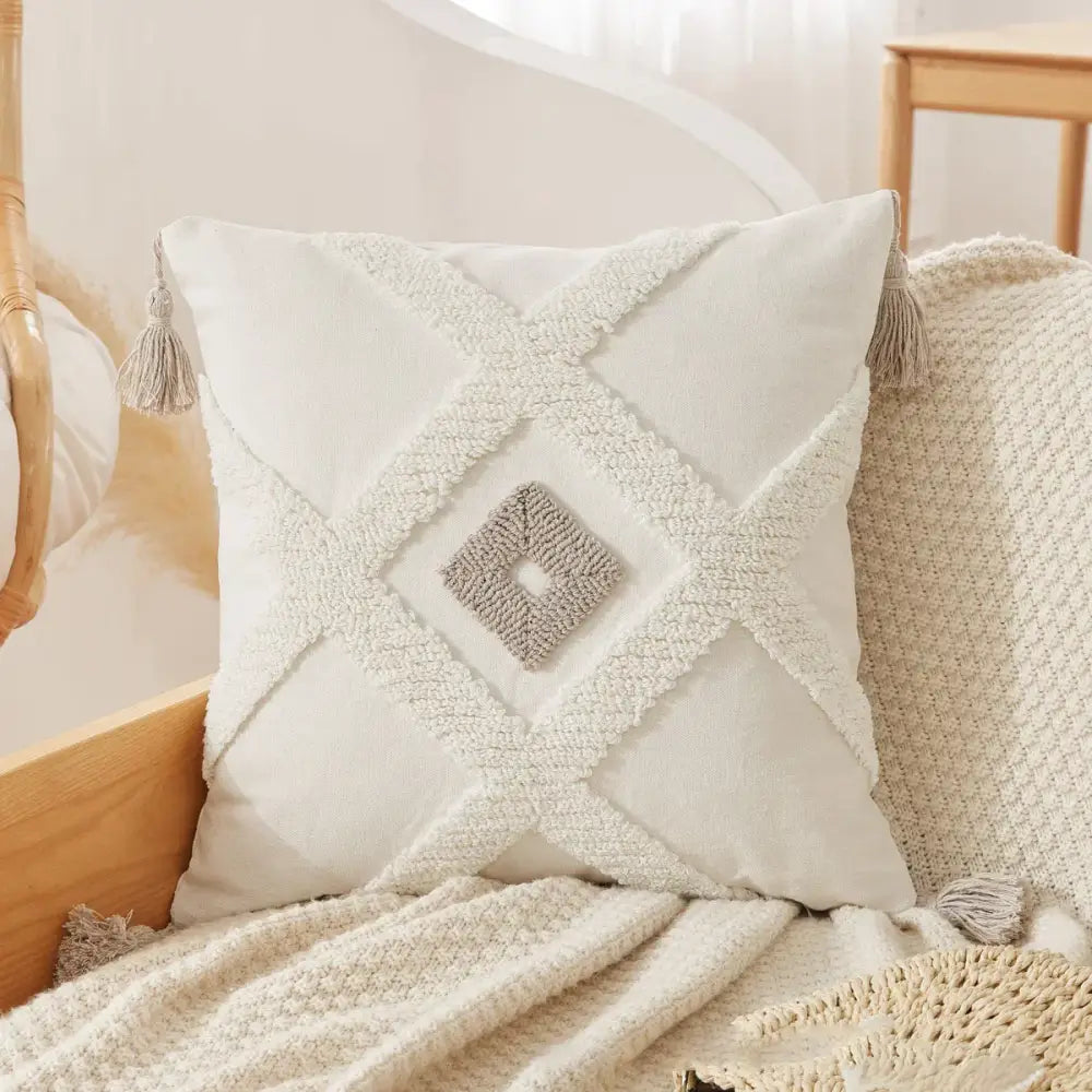 Cream-colored square pillow case with textured white fabric and gray knitted diamond accent for decorbites boho beige white decor