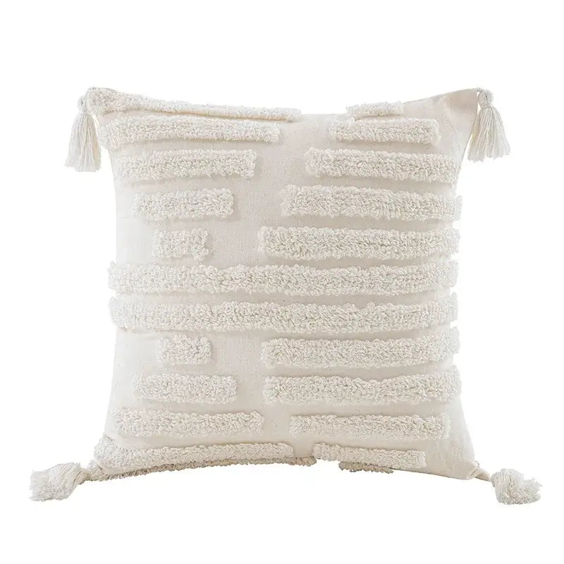 Cream-colored boho beige white tufted tassel pillow cover with textured horizontal stripes and corner fringe tassels for decorbites