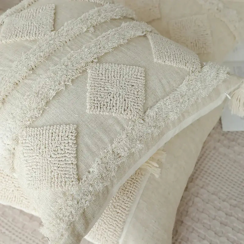 Cream-colored boho beige white tufted pillow with woven diamond patterns and frayed edges for bedroom decorbites decor