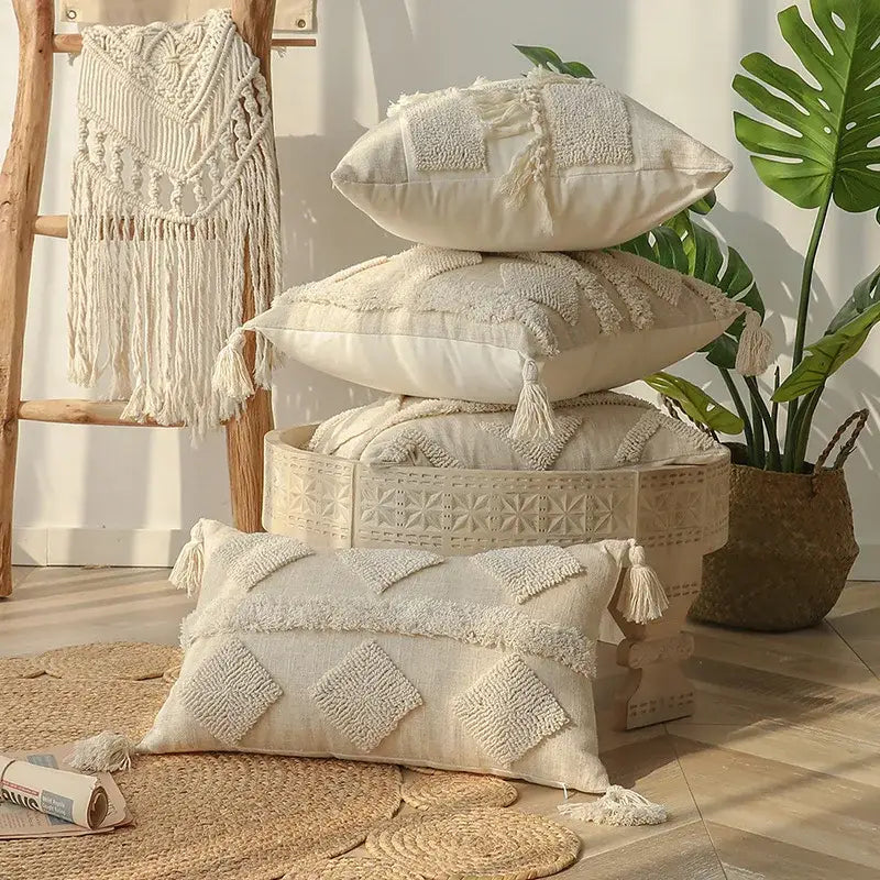 Stack of cream-colored boho beige white tufted tassel pillow covers with embroidered diamond patterns for bedroom decor