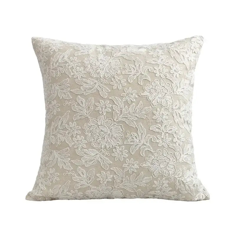 Beige square pillow cover with intricate white floral embroidery made of linen cotton for boho living room decor