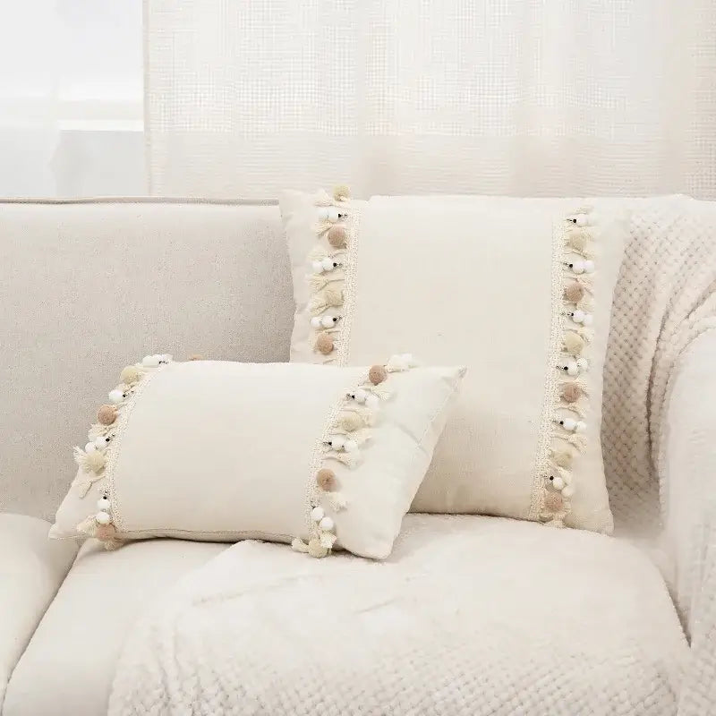 Cream-colored boho pillow cover with pom-pom lace trim made of linen cotton for living room decor
