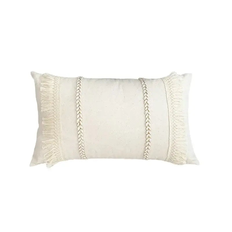 Cream-colored rectangular pillow cover with textured linen cotton fabric, braided cord accents, and fringed edges for living room decor
