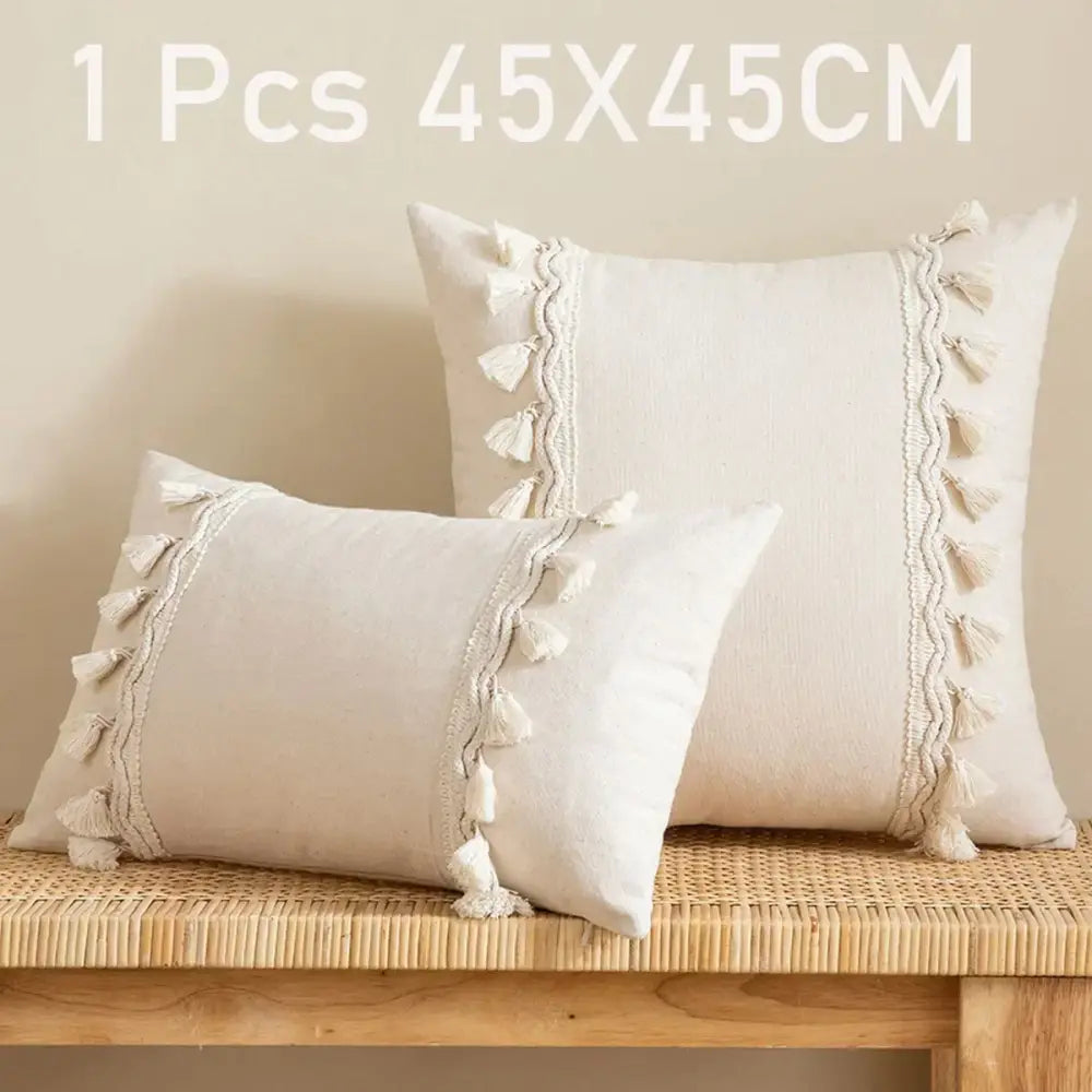 Cream-colored rectangular pillow cover with tassel trim made of linen cotton for boho living room decor