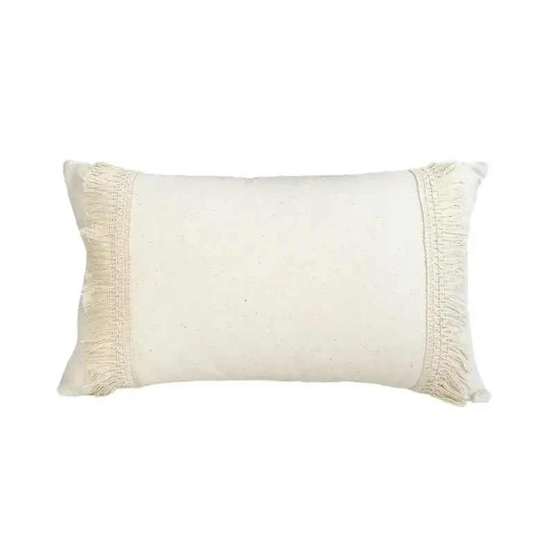 Cream-colored rectangular pillow cover with fringed edges made of linen cotton for boho living room decor