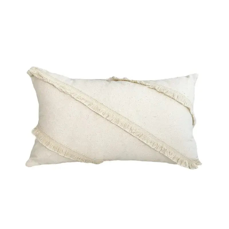 Cream-colored linen cotton pillow cover with two diagonal fringed fabric strips for boho living room decor