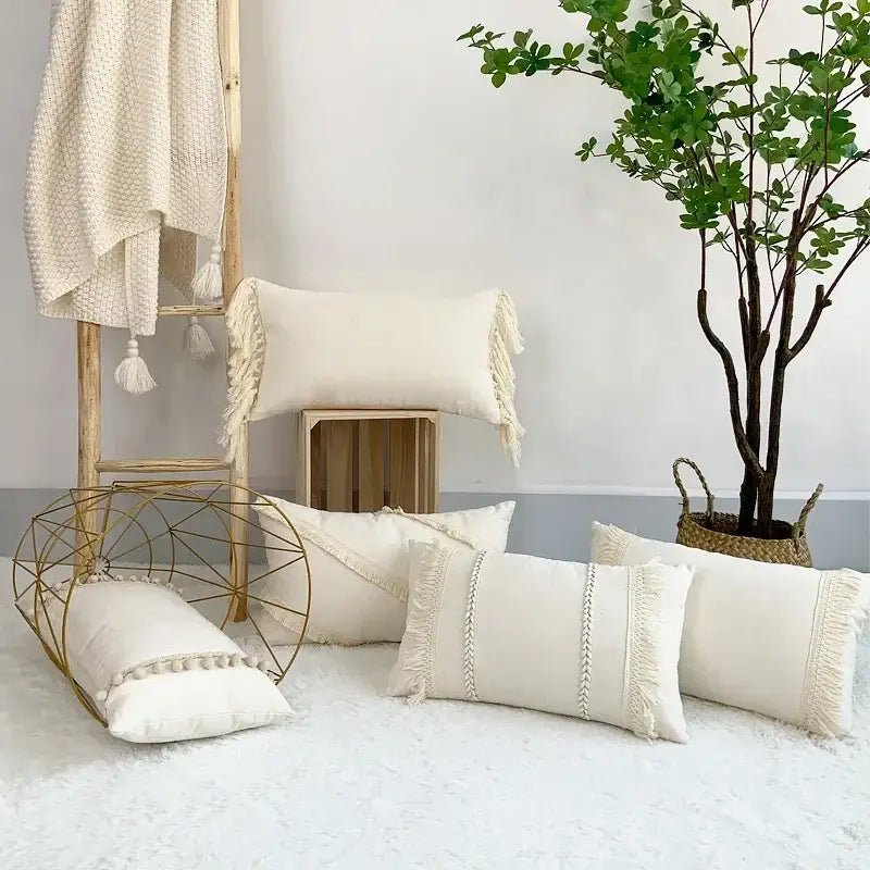 Cream-colored linen cotton pillow covers with fringed edges and woven detailing for living room decor