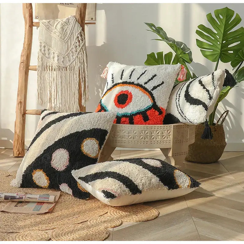 White fluffy boho big eye tufted cushion covers with bold black and orange eye designs for bedroom decorbites boho big