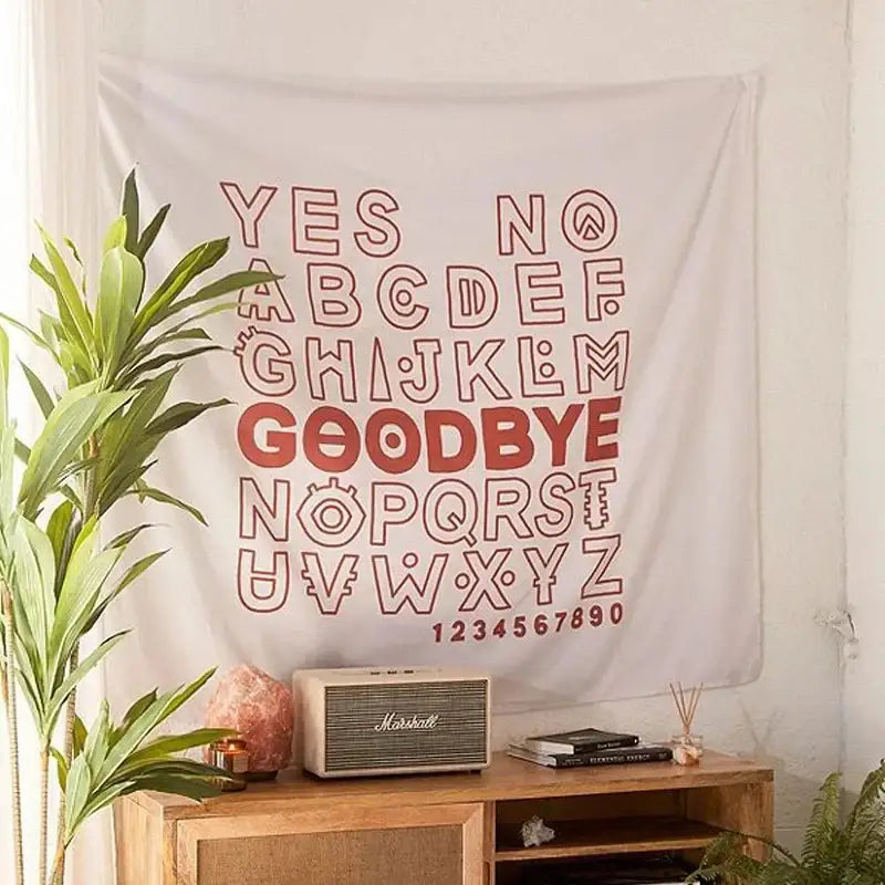 White wall hanging with red outlined retro letters and numbers in a boho black and white divination tapestry pink ouija design