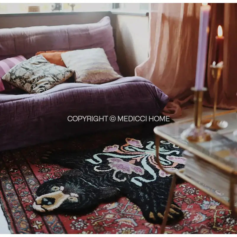 Boho black bear rug with intricate pink and white floral embroidery on a red patterned carpet for bedroom decorbites boho black