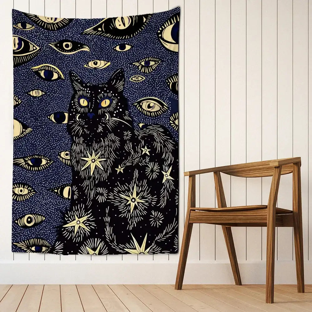 A dark blue boho cat eyes tapestry with a black cat, glowing yellow eyes, and gold celestial wall decor