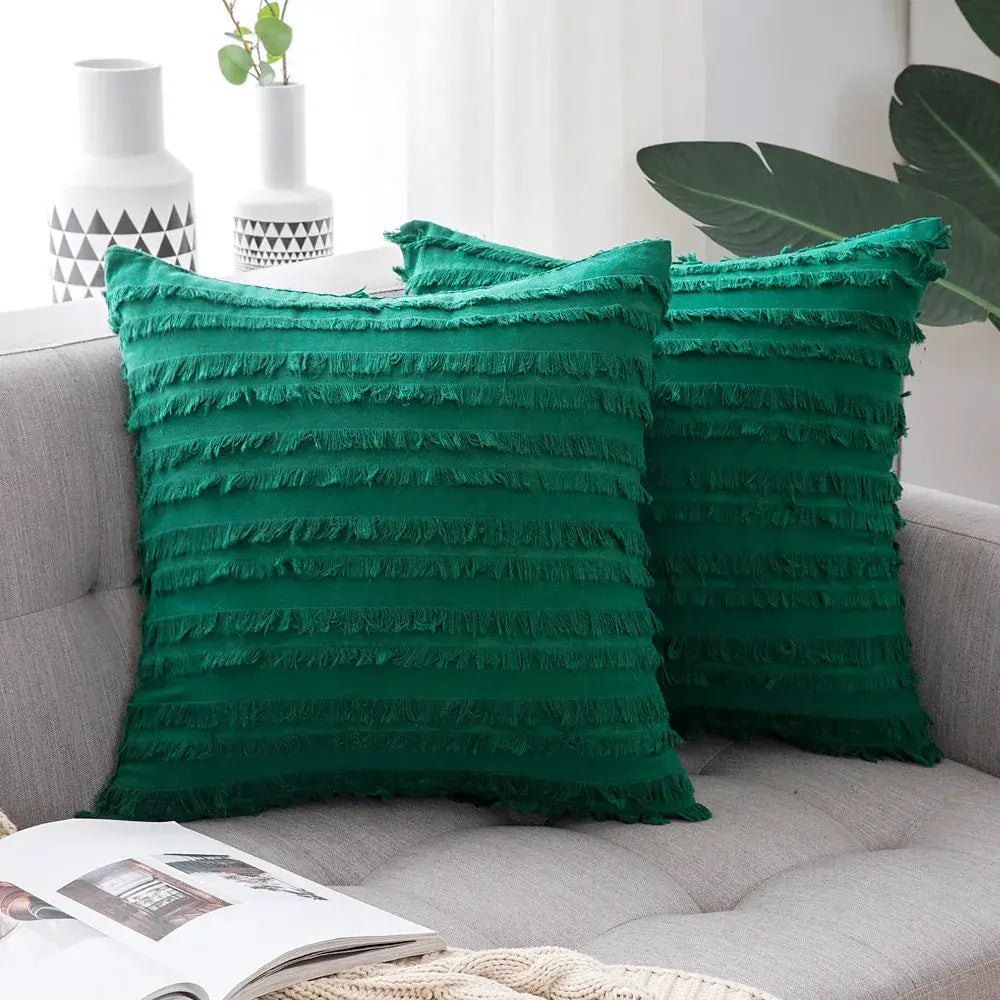Emerald green throw pillow covers with layered fringe detailing and boho black tassel striped design for home decor