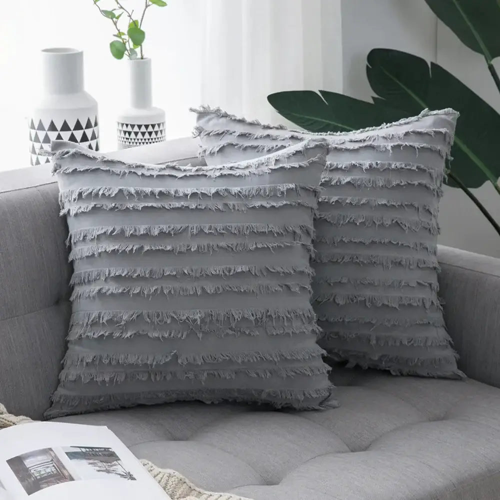 Gray throw pillow covers with layered frayed fabric detailing and boho black tassel striped design for home decor