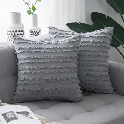 Gray throw pillow covers with layered frayed fabric detailing and boho black tassel striped design for home decor