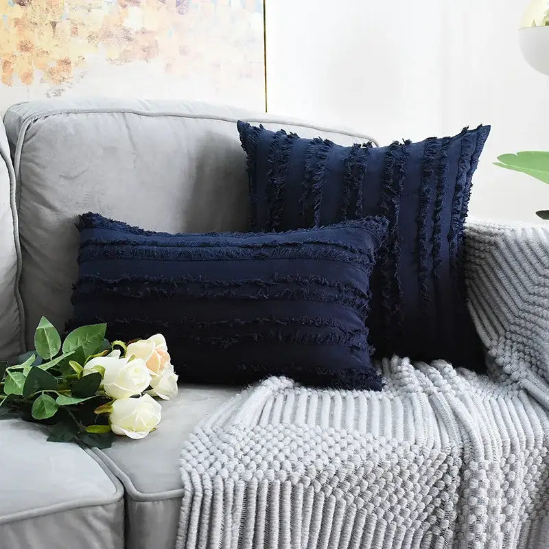 Navy blue textured throw pillow covers with frayed edge detailing and tassel striped design for boho home decor