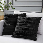 Boho black tassel striped pillow covers featuring textured fabric and frayed horizontal stripes for home decor