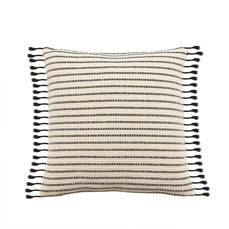 A square throw pillow case with cream and black striped jacquard flower pattern and tassels for decorbites boho decor