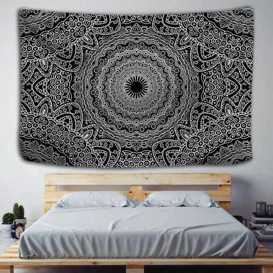 Boho black and white mandala tapestry with intricate swirling patterns hanging as a decorbites indian mandala wall hanging above a wooden bed frame