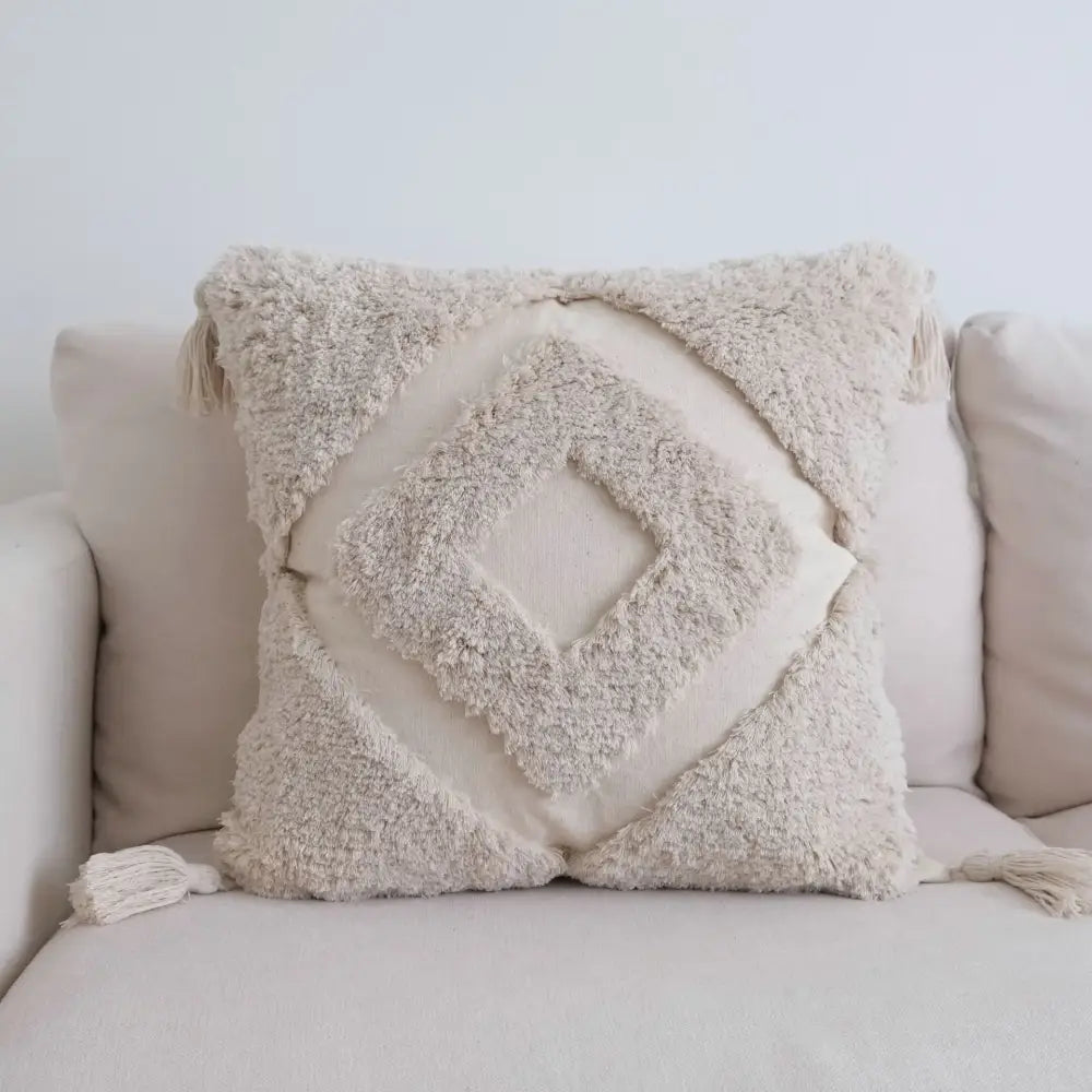 Beige textured cushion cover with layered diamond pattern and tassels for boho tufted tassel cushion decor