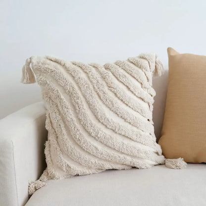 Cream-colored tufted tassel cushion cover with woven tassels and plush fabric for boho living room decor