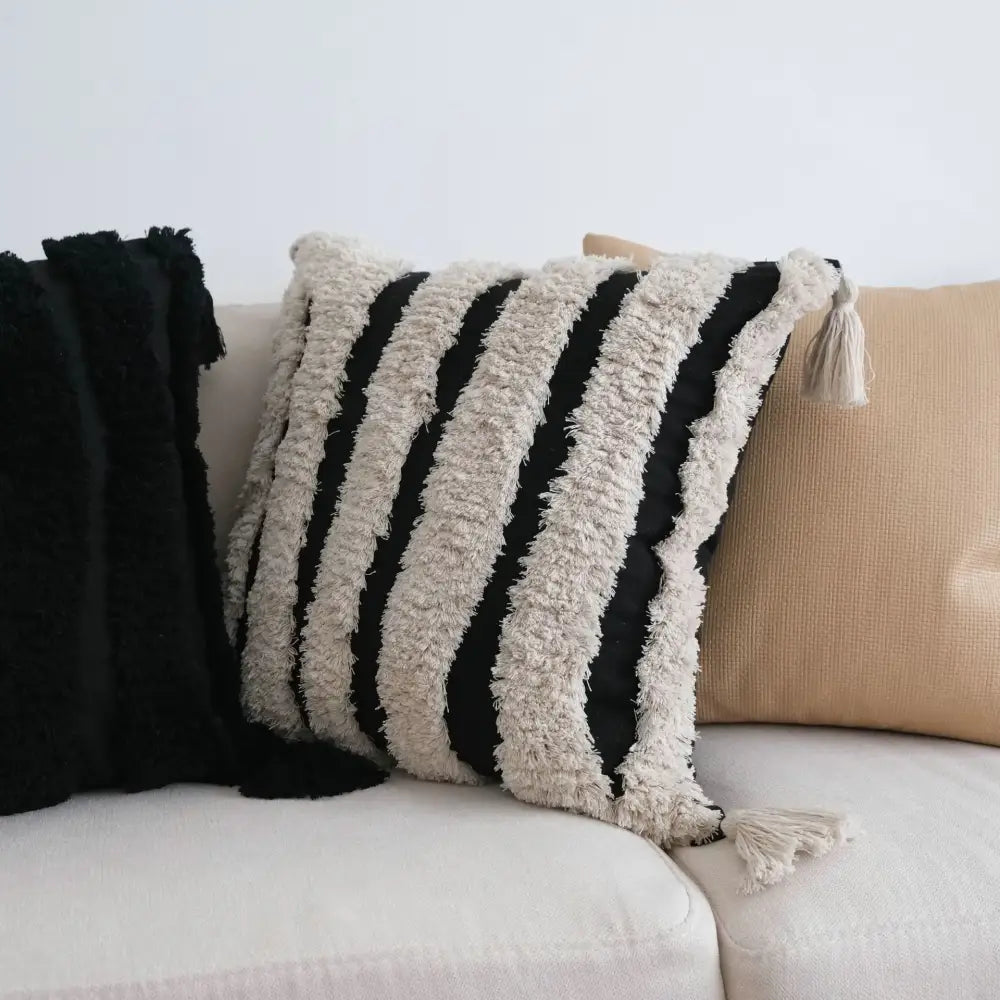 Black and cream striped tufted tassel cushion cover with fringed edges for boho living room decor