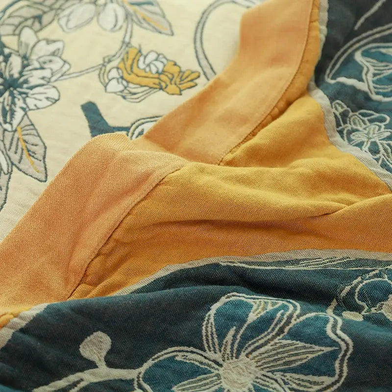 A soft mustard yellow cotton lining with subtle texture on the back of a boho blue and cream cover blanket sofa chair by decorbites