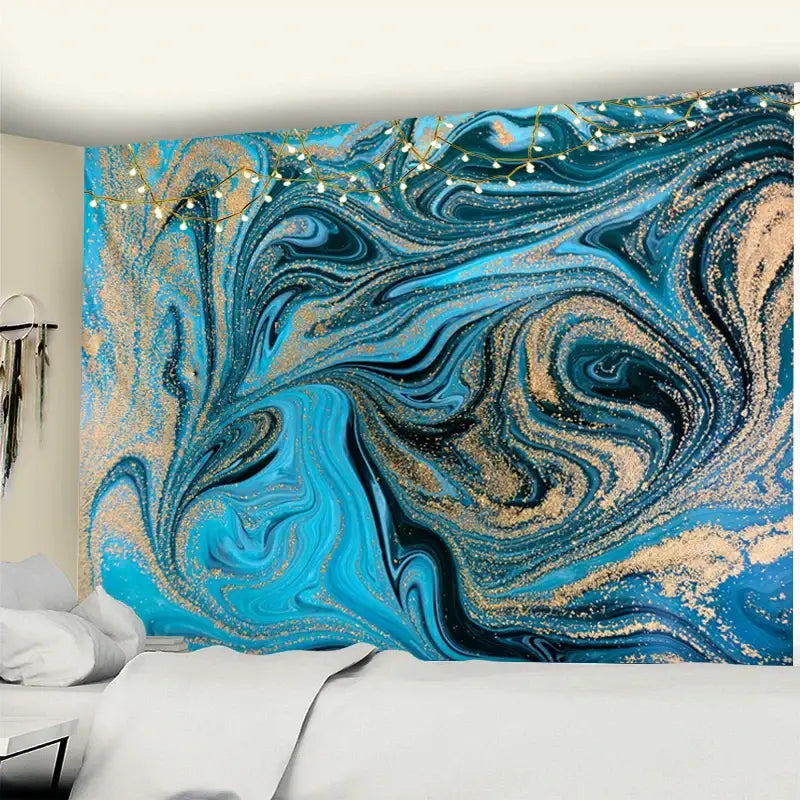 Boho blue gouache line marbled tapestry in vibrant blue and gold with swirling patterns hanging above a bed
