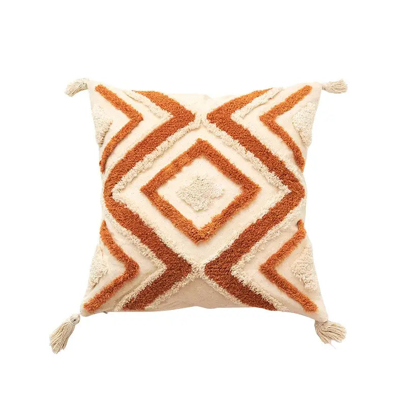 Cream-colored boho chenille tufted pillow case with rust-orange geometric embroidery and tassels for living room decorbites decor