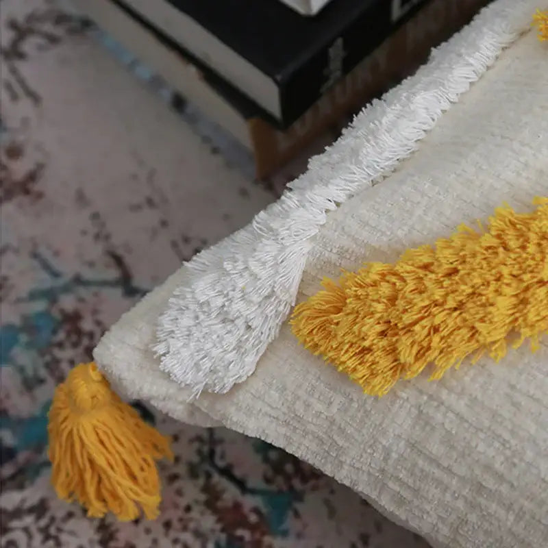 Cream-colored boho chenille tufted pillow case with white and yellow tassels for living room decorbites decor