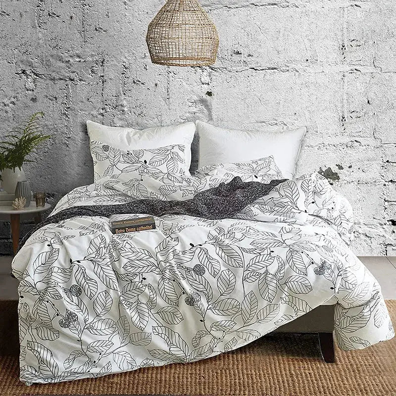White duvet cover with black leaf and berry illustrations in a boho chic bedding set by decorbites boho chic