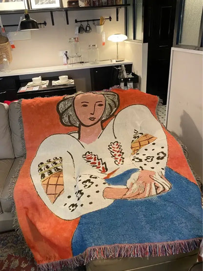 Vibrant orange and blue decorbites boho chic throw blanket with white stylized woman and leopard print accents and fringe