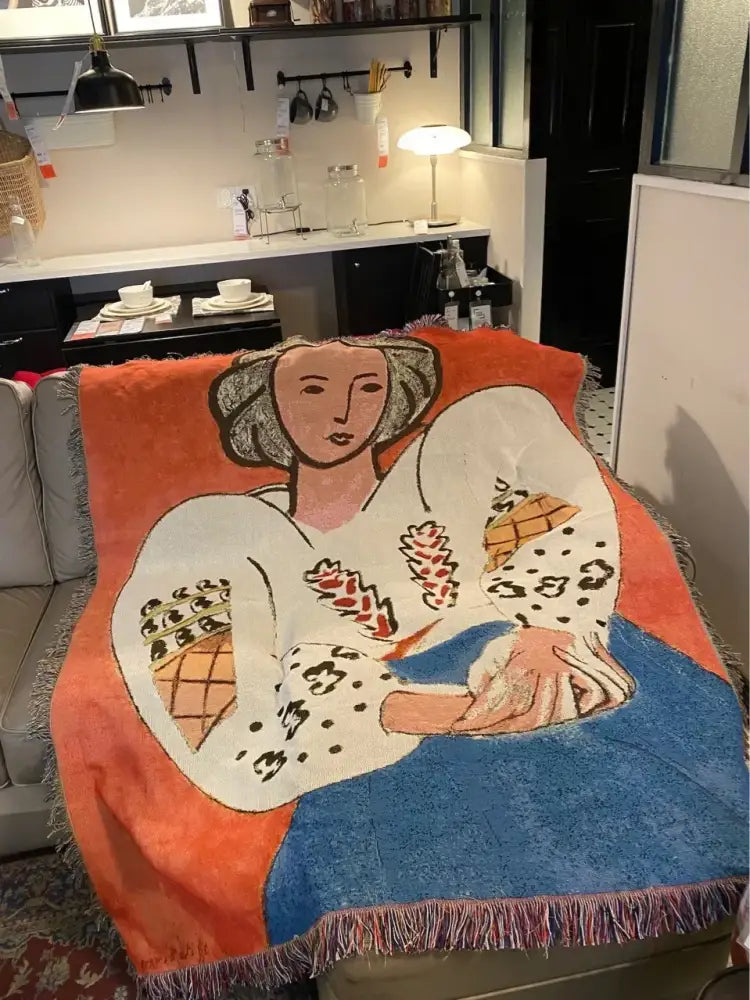 Vibrant orange and blue decorbites boho chic throw blanket with white stylized woman and leopard print accents and fringe