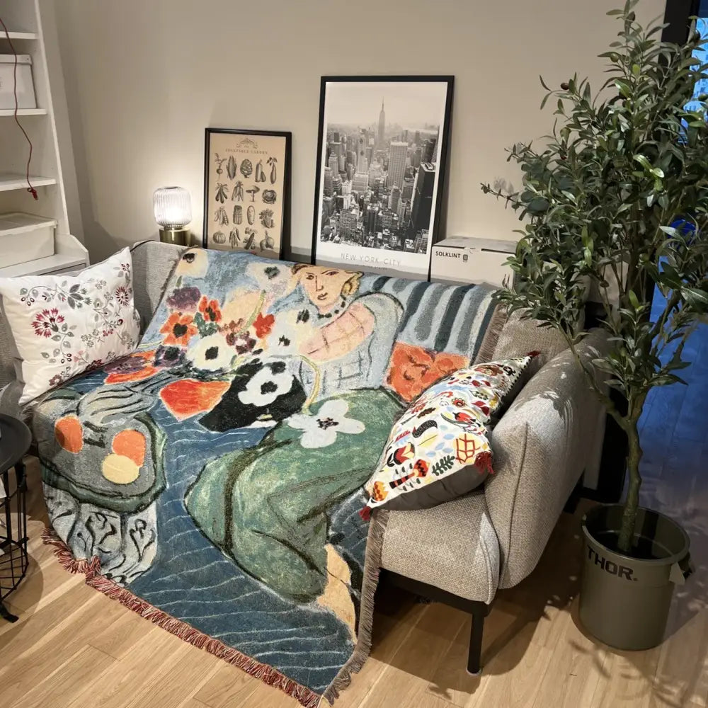 A decorbites boho chic throw blanket with orange and blue leopard print and a vibrant woman floral design in soft pastels