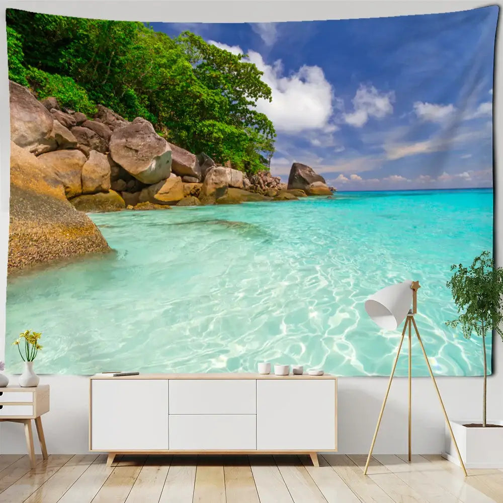 Boho coastal cave tapestry wall hanging with turquoise beach scene, green trees, and rocky shores for seaside decorbites decor