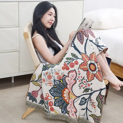 A cozy cream woven throw blanket with vibrant orange pink and blue floral pattern for decorbites boho cotton gauze bath towel