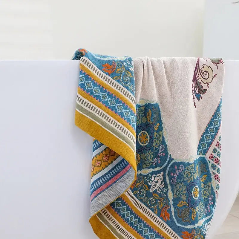 A soft boho cotton gauze bath towel with vibrant blue and yellow floral and geometric patterns for decorbites bathroom wrap