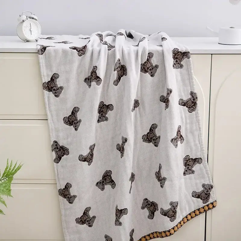 White blanket with black teddy bear prints and brown checkered border in decorbites boho cotton gauze bath towel design