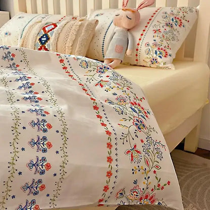 White boho cotton printed duvet cover with intricate red blue and green floral embroidery in decorbites bedding set