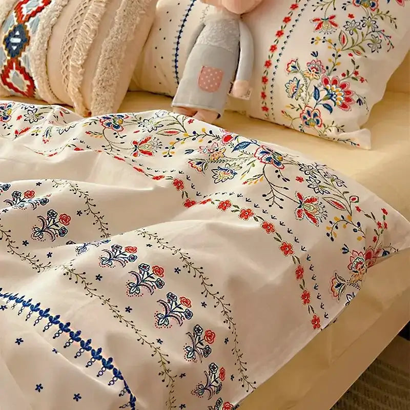 Cream-colored boho cotton printed duvet cover with intricate red blue and green floral embroidery from decorbites bedding set