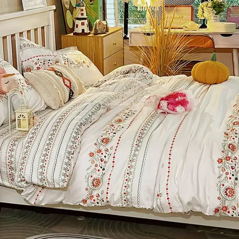 White duvet set with embroidered red orange and green floral patterns along vertical stripes in decorbites boho cotton printed bedding set
