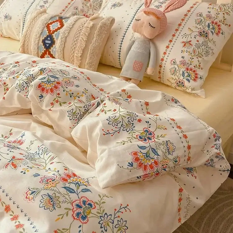 Cream-colored boho cotton printed floral bedding set with embroidered red orange and blue blossoms for bedroom decor