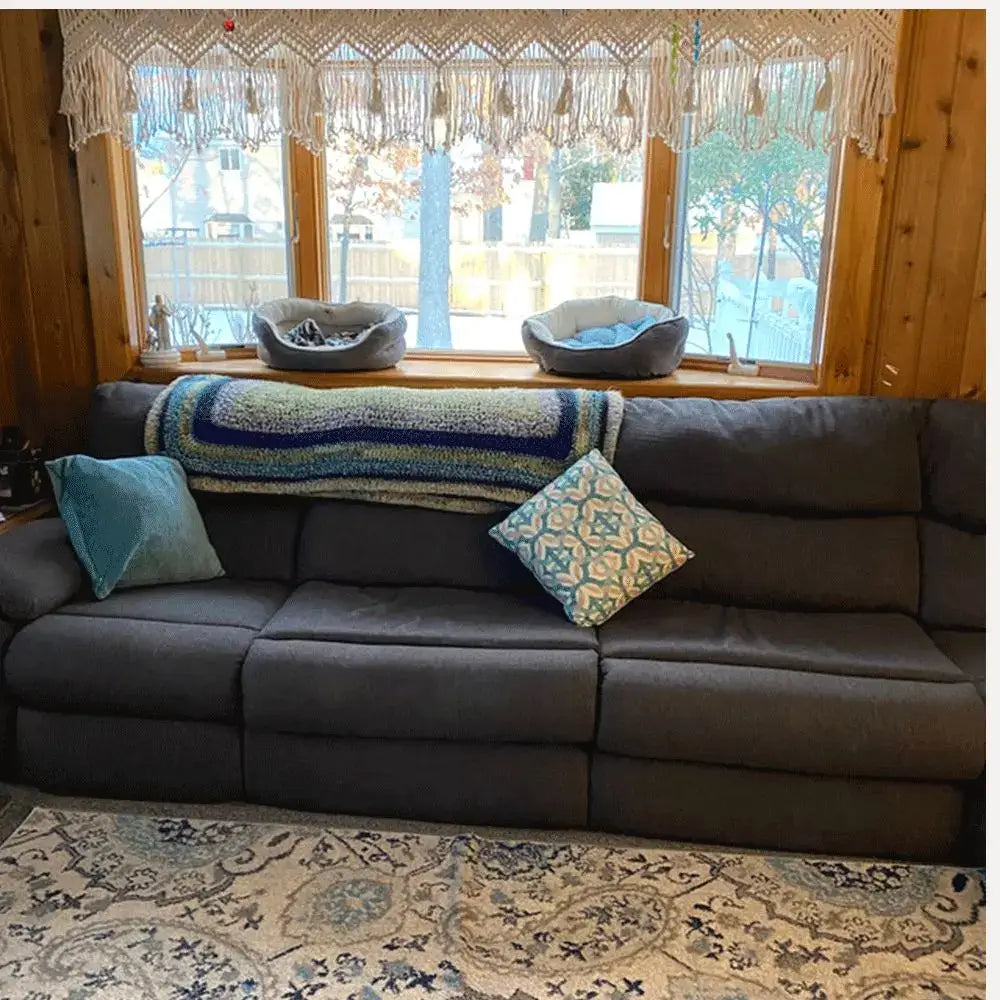 Dark gray sectional sofa with plush cushions and decorative pillows complementing decorbites boho cotton wove door curtain