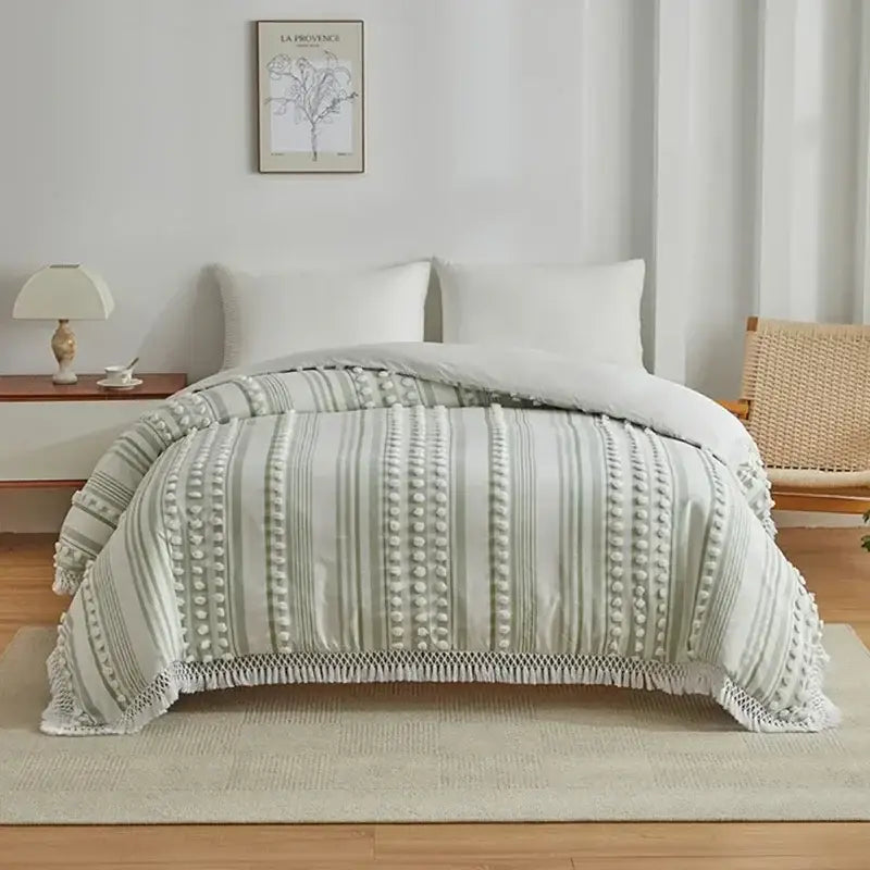 Soft sage green quilt with textured vertical stripes and pom poms edges from decorbites boho stripe duvet set