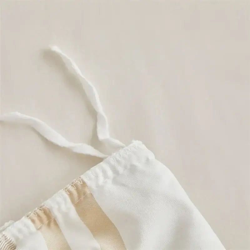 White drawstring waistband with beige fabric stripes and elastic gathering on boho stripe furball duvet set by decorbites